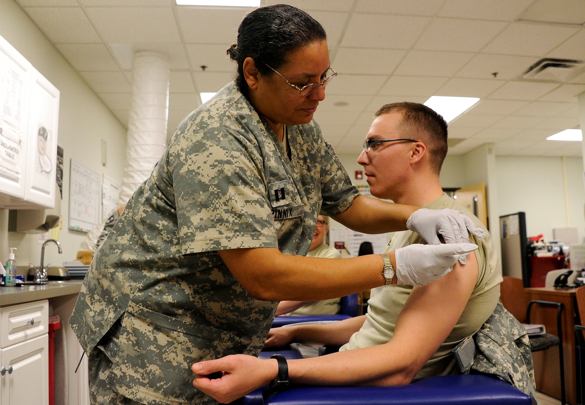 Capt. Margaret Pinnix, Walson Medical Support Element immunizations officer-in-charge, gives Staff Sgt. David Schmalz, 147th Human Resources Company transport management coordinator, his anthrax immunization Dec. 9 before he heads down range for his deployment. The WMSE administered more than 13,000 immunizations from Jan. 1 to Nov. 15, 2011. (U.S. Air Force photo by Airman Ryan Throneberry/Released)
