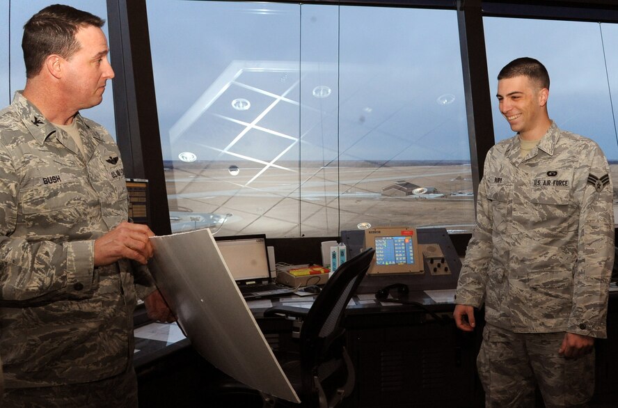 Col. Timothy Bush, 319th Air Base Wing Commander, surprises Senior Airman Matthew Burt, 319th Operations Support Squadron, with tickets to Super Bowl XLVI after being drawn as the winner of the Air Mobility Command portion of the Air Force-wide “Football Frenzy” contest Jan. 10 on Grand Forks Air Force Base, N.D.  The prize includes a four-day all-expenses paid trip and tickets to Indianapolis, Ind., for this year’s Super Bowl. (U.S. Air Force photo by Airman 1st Class Xavier Navarro)