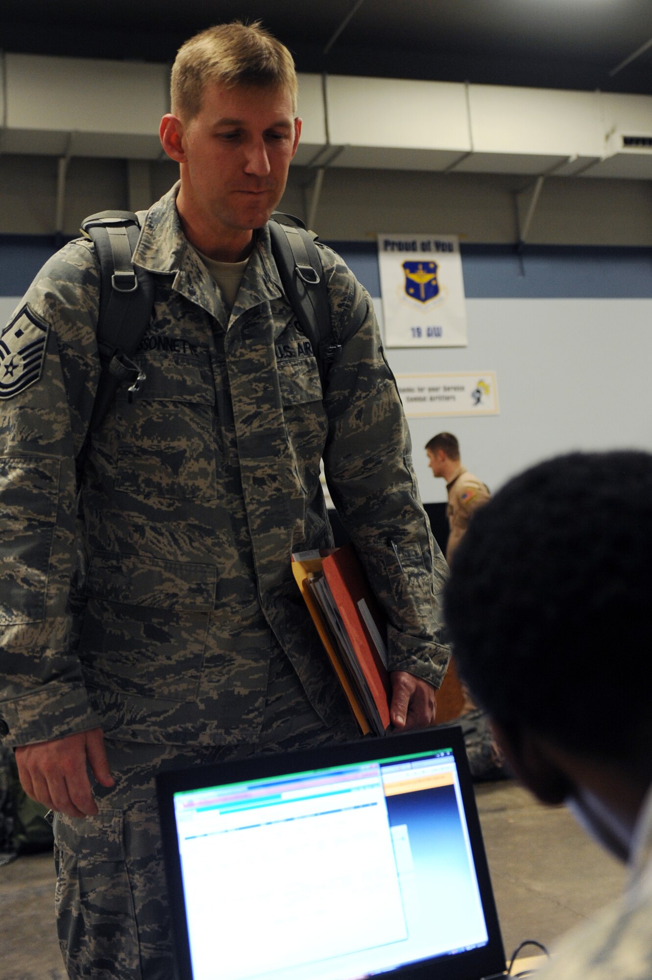 Master Sgt. Bryan Bissonette, 19th Communications Squadron first sergeant, processes in line prior to deployingJan. 10, 2012, at Little Rock Air Force Base, Ark. Bissonette deployed with nearly 200 other Airmen to support combat operations in Southwest Asia. (U.S. Air Force Photo by Airman 1st Class Rusty Frank)