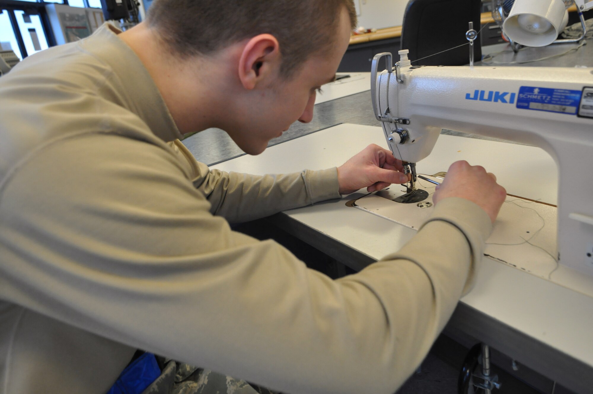 Airman 1st Class David Prylo, 62nd Operations Support Squadron aircrew flight equipment technician, prepares equipment to be loaded rigged into a parachute Jan. 11, 2012, at Joint Base Lewis-McChord, Wash. (U.S. Air Force photo/Airman 1st Class Leah Young)