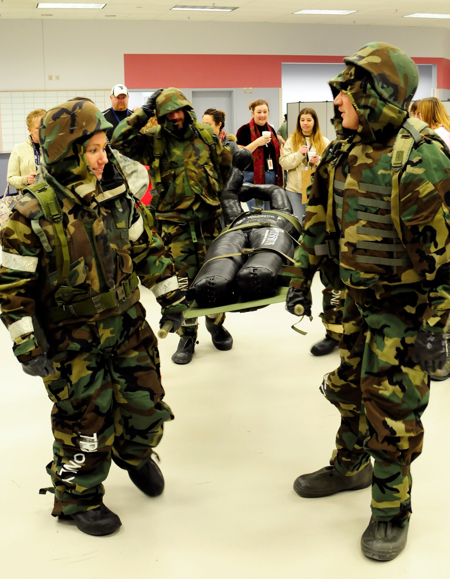 Teachers attending Operation Bug Out practice transporting a medical litter Jan. 6, 2012, Eielson Air Force Base, Alaska. The event offered educators an opportunity to experience some of the same activities that servicemembers may see prior to deploying as well as in a deployed environment. (U.S. Air Force photo by Airman 1st Class Yash Rojas/Released)