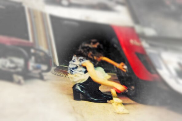 A photo on the wall shows Master Sgt. Marty Stanton's daughter Alicia removing the beauty rings from his 1976 Stingray Corvette at their home in Goldsboro, N.C., Jan. 5, 2012. Alicia, three years old at the time, had put on her mother's boots and asked her father if she could help him work on cars. Since then she helps her dad strip, prime, paint and repair cars and trucks. Stanton is a 4th Logistics Readiness Squadron vehicle management superintendent. (U.S. Air Force photo illustration by Senior Airman Rae Perry)