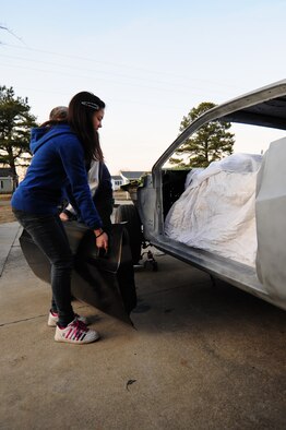 Alicia, 12, helps her father, Master Sgt. Marty Stanton, place a door onto a 1974 Dodge Challenger at their home in Goldsboro, N.C., Jan. 5, 2012. Stanton has worked on cars since taking a vocational class at his high school and will continue to restore them well into the future. Stanton is a 4th Logistics Readiness Squadron vehicle management superintendent. (U.S. Air Force photo by Senior Airman Rae Perry)