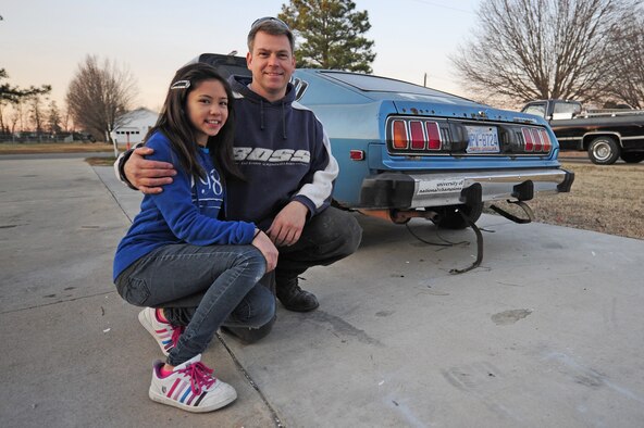 Master Sgt. Marty Stanton and his daughter Alicia, 12, pose for a photo in front of their 1977 Toyota Celica GT at their home in Goldsboro, N.C., Jan. 5, 2012. Alicia has helped her father in the garage since she was three years old and enjoys working and hanging out with him. Stanton is a 4th Logistics Readiness Squadron vehicle management superintendent. (U.S. Air Force photo by Senior Airman Rae Perry)