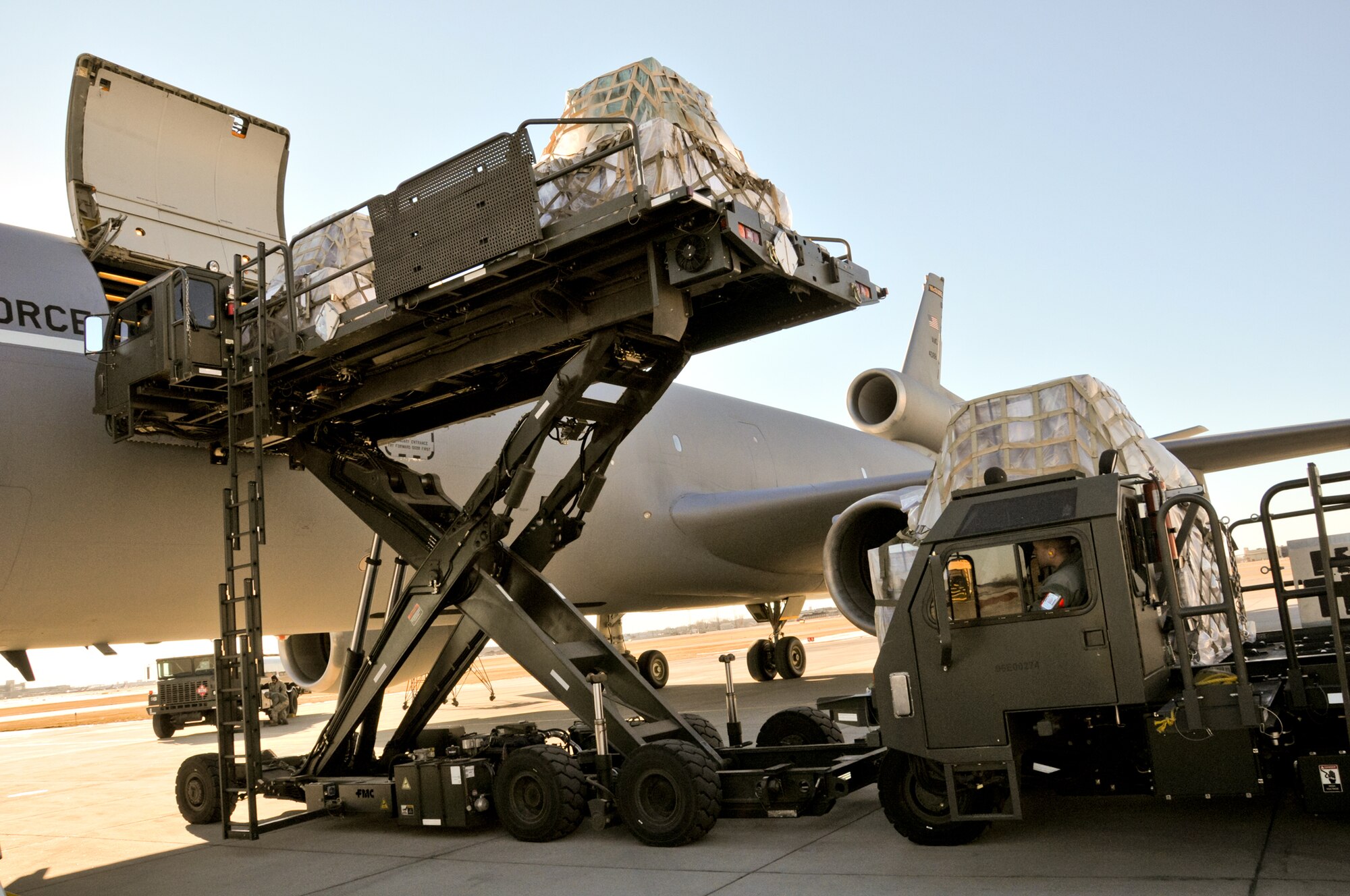 Pallets of supplies from relief organization Feed My Starving Children are loaded onto a KC-10 at the Minneapolis Air Reserve Station, Minn.  The Denton Program allows donors to put available space aboard U.S. Military transport to use by providing humanitarian relief transportation.  (Air Force Photo/Paul Zadach)