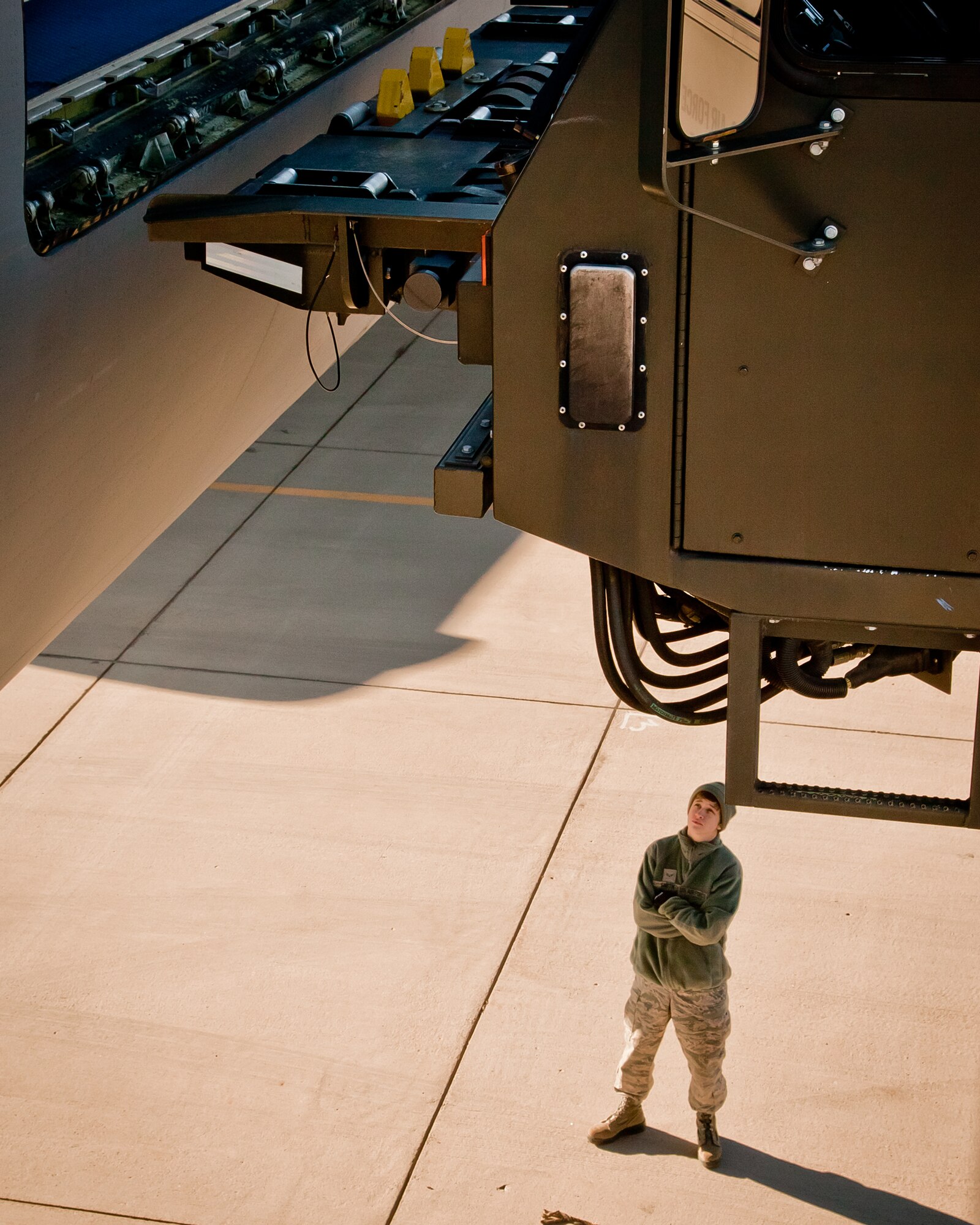 Airman First Class Alyssa Smith of the 133rd Airlift Wing monitors the alignment of a Halvorsen loader as it interfaces with a KC-10 to load pallets for a Denton program shipment at the Minneapolis Air Reserve Station, Minn.  (Air Force Photo/Shannon McKay)