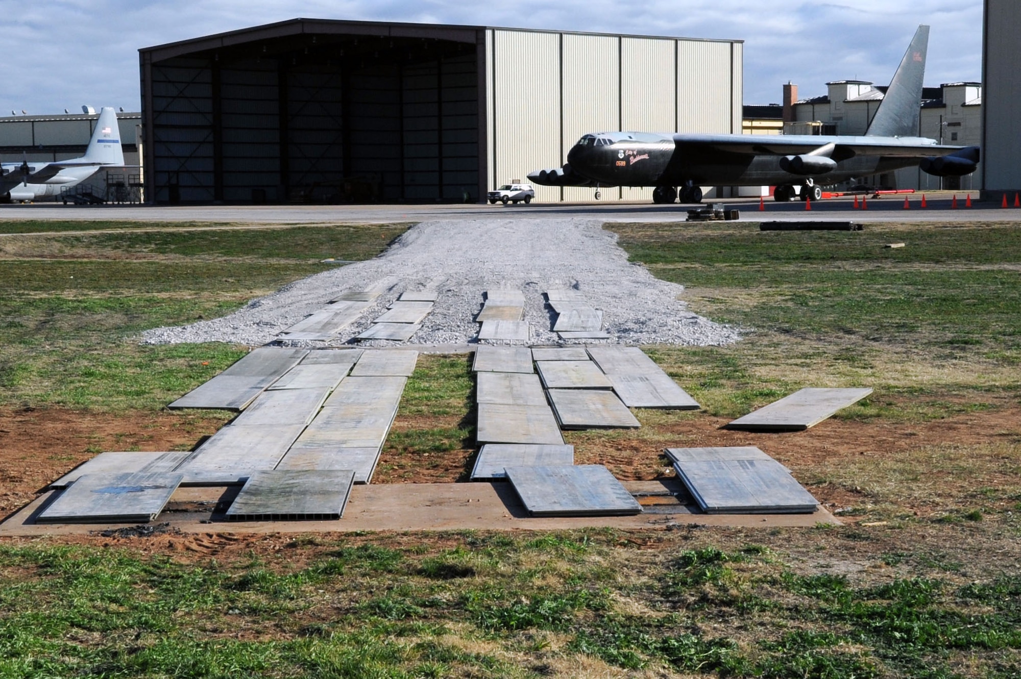 The “City of Burkburnett” B-52 has been removed from where it has sat since 1991, and waits in the background for transport to its new location.  The B-52 is being replaced with a newer model due to years of outdoor elements making the plane structurally unstable. (U.S. Air Force Photo/ Josh Wilson)