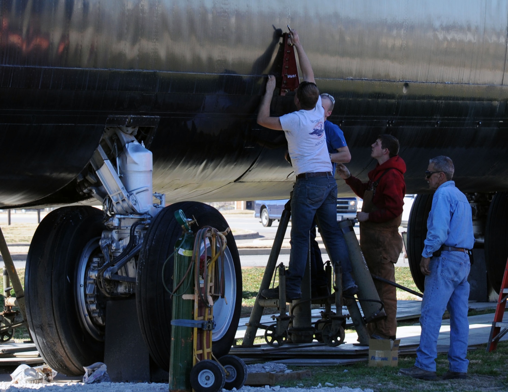 Members of Worldwide Aircraft Recovery prepare the "City of Burkburnett" B-52 to be removed from its stands and ready for transport.  The B-52 must be replaced due to years of wear and tear from being exposed to the outdoor elements. (U.S. Air Force Photo/ Josh Wilson)