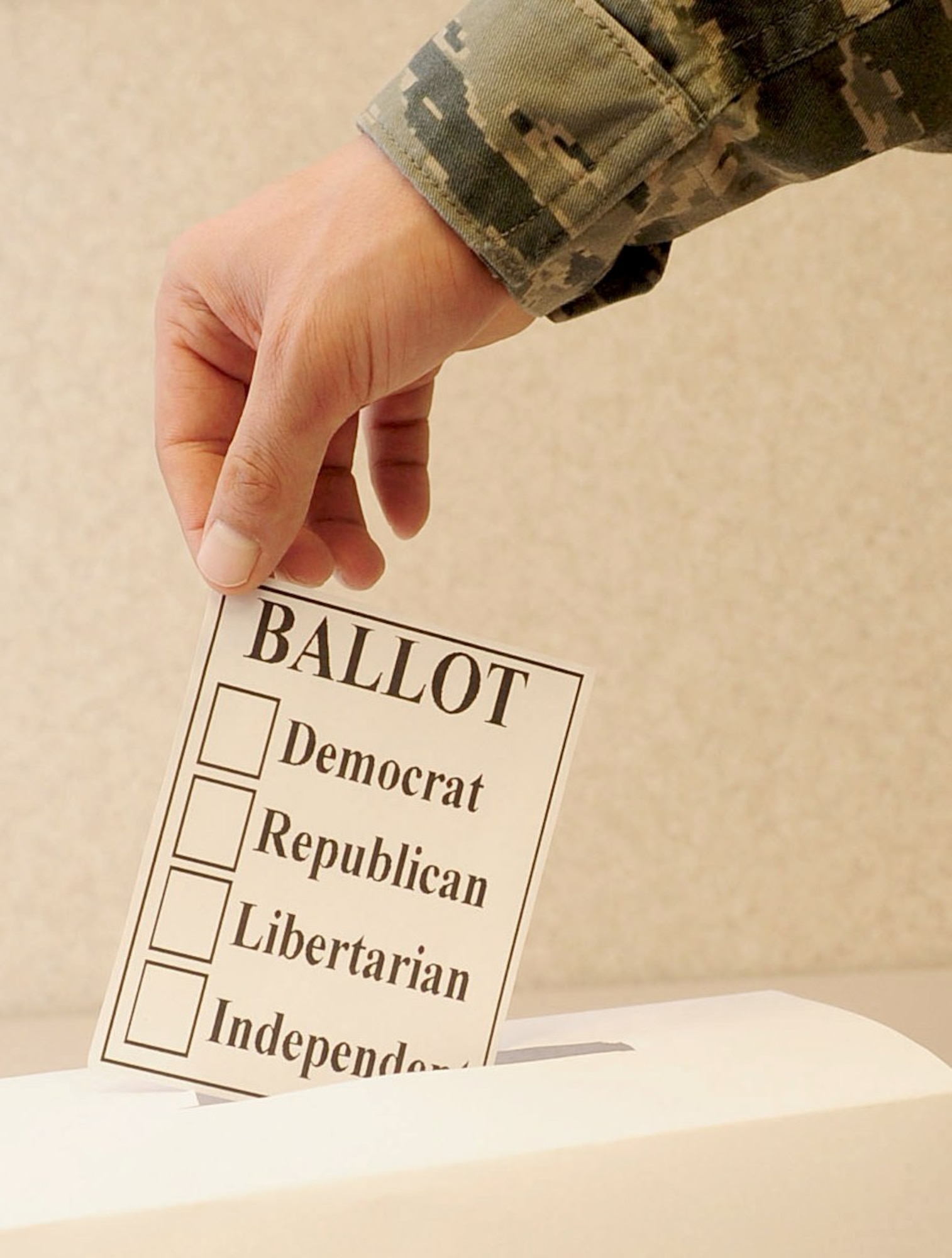 U.S. Air Force Staff Sgt. Shawn Bryant, 633rd Air Base Wing broadcaster, turns in his voting ballot at Langley Air Force Base, Va., Jan. 10, 2012. Although servicemembers are allowed to vote, the military as a whole is a non-partisan organization, and it is important that the public see the Armed Forces as politically neutral. (U.S. Air Force photo by Staff Sgt. Ashley Hawkins/Released)