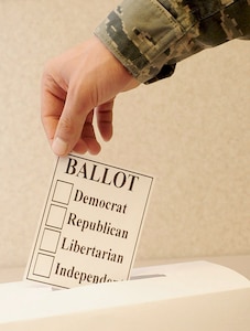 U.S. Air Force Staff Sgt. Shawn Bryant, 633rd Air Base Wing broadcaster, turns in his voting ballot at Langley Air Force Base, Va., Jan. 10, 2012. Although servicemembers are allowed to vote, the military as a whole is a non-partisan organization, and it is important that the public see the Armed Forces as politically neutral. (U.S. Air Force photo by Staff Sgt. Ashley Hawkins/Released)