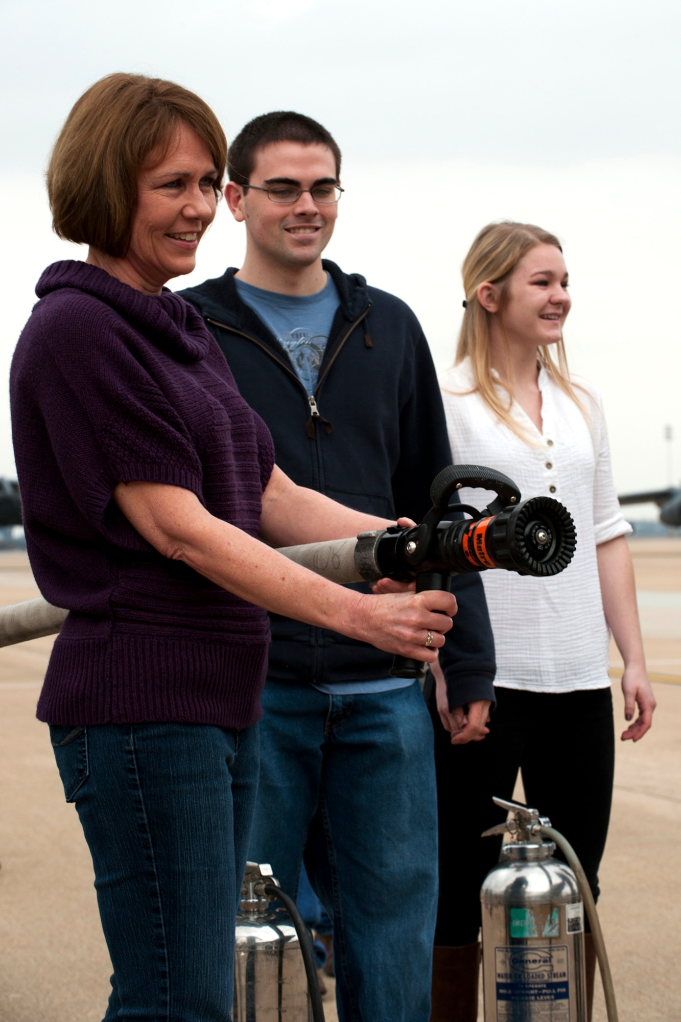 Linda Rounds, wife of U.S. Air Force Lt. Col. Chris Rounds, anxiously waits to spray down her husband after his return from a B-52 mission at Barksdale Air Force Base, La., Jan. 8, 2012. Rounds is retiring from the Air Force Reserve and this was his last flight in a B-52. (U.S. Air Force photo by Master Sgt. Greg Steele/Released)
