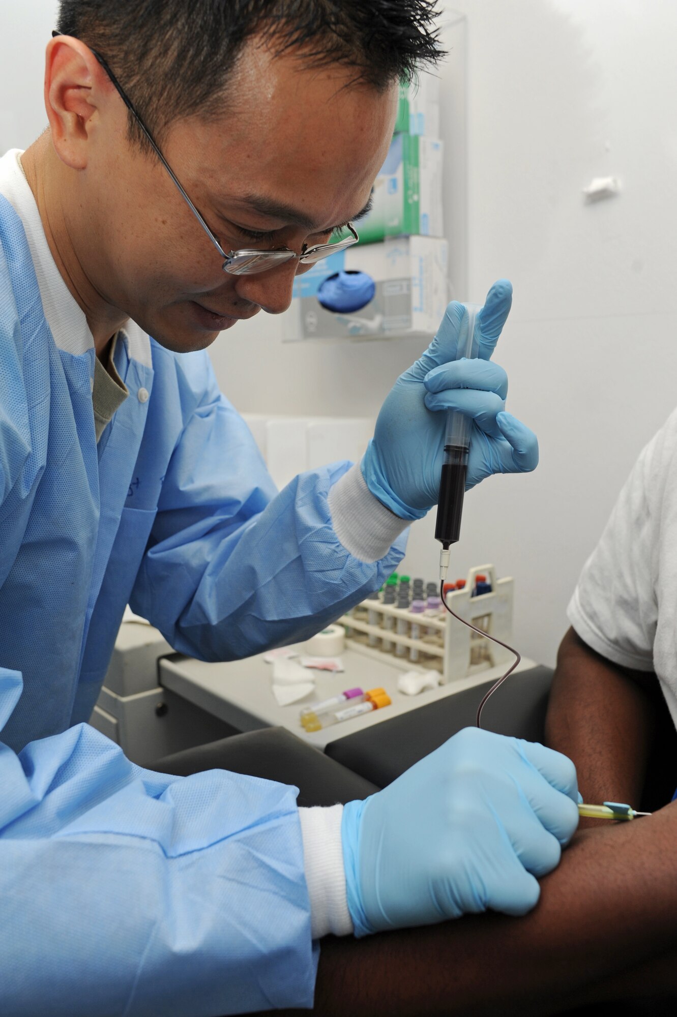 SPANGDAHLEM AIR BASE, Germany – Staff Sgt. Chhouen Prach, 52nd Medical Support Squadron laboratory technician, draws blood from a patient at the clinic here Jan. 10. The laboratory technicians collect and test urine and blood samples for the diagnosis, treatment and prevention of diseases. These preventative measures help physicians provide the best possible healthcare to Saber Airmen and their families, retirees and Department of Defense employees. (U.S. Air Force photo/Airman 1st Class Matthew B. Fredericks)