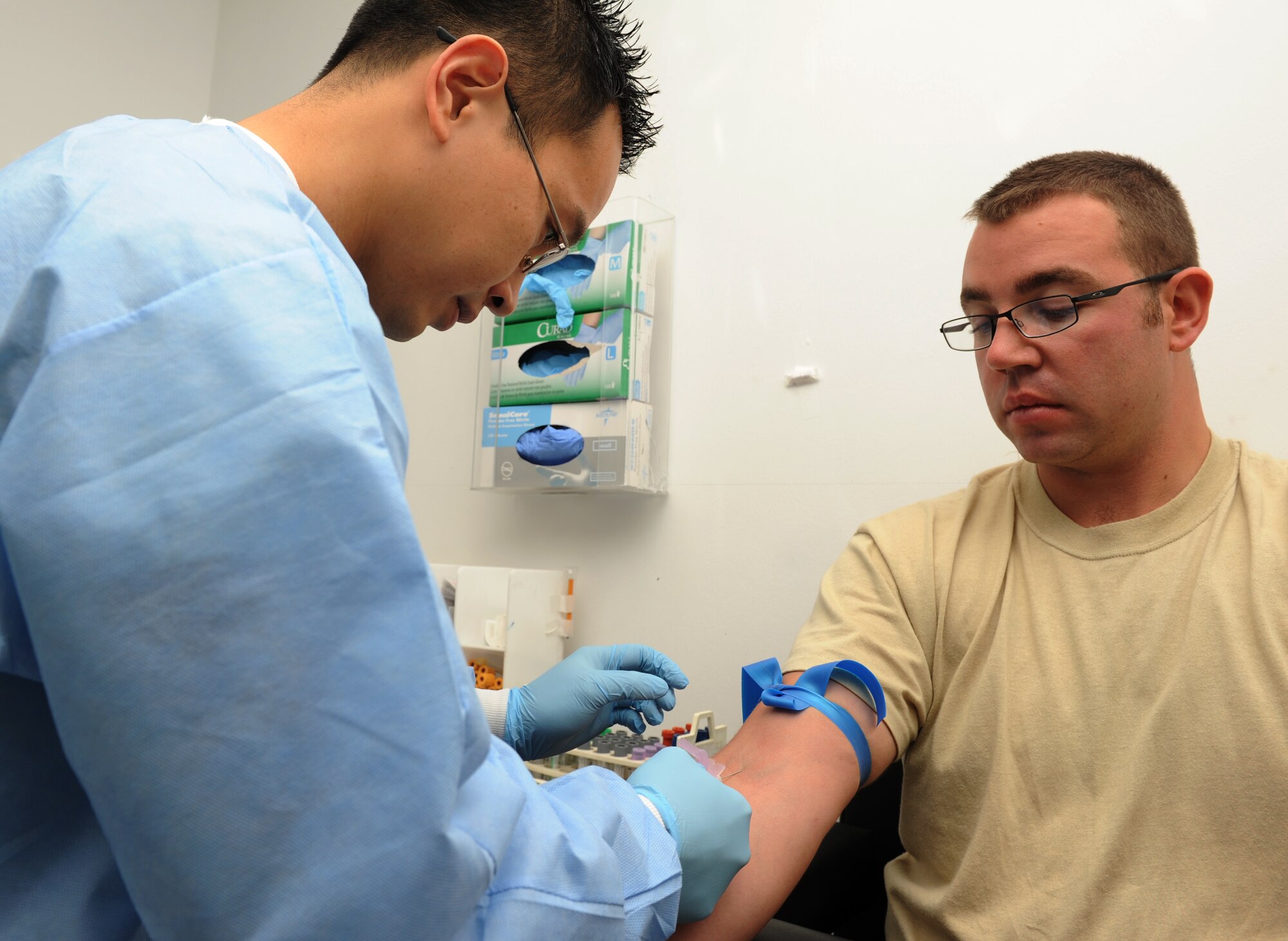 SPANGDAHLEM AIR BASE, Germany – Staff Sgt. Chhouen Prach, 52nd Medical Support Squadron laboratory technician, draws blood from Staff Sgt. Timothy Fordham, 52nd Comptroller Squadron, at the clinic here Jan. 10. The laboratory technicians collect and test urine and blood samples for the diagnosis, treatment and prevention of diseases. These preventative measures help physicians provide the best possible healthcare to Saber Airmen and their families, retirees and Department of Defense employees. (U.S. Air Force photo/Airman 1st Class Matthew B. Fredericks)