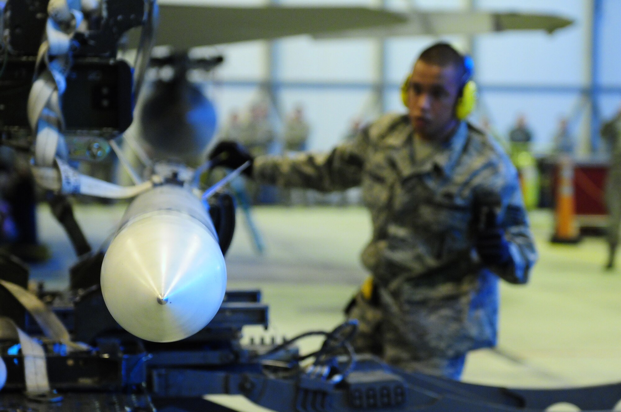 ROYAL AIR FORCE LAKENHEATH, England -- Staff Sgt. Melvin Alejandro, 493rd Aircraft Maintenance Unit weapons load crew team chief, prepares munitions for transport during the quarterly Load Crew Competition, Jan. 6, 2012. The quarterly competition features the best load crew teams from the 492nd, 493rd and 494th AMUs. The winner is determined by the fastest time loading munitions with the least amount of errors.  (U.S. Air Force photo by Senior Airman Lausanne Morgan)