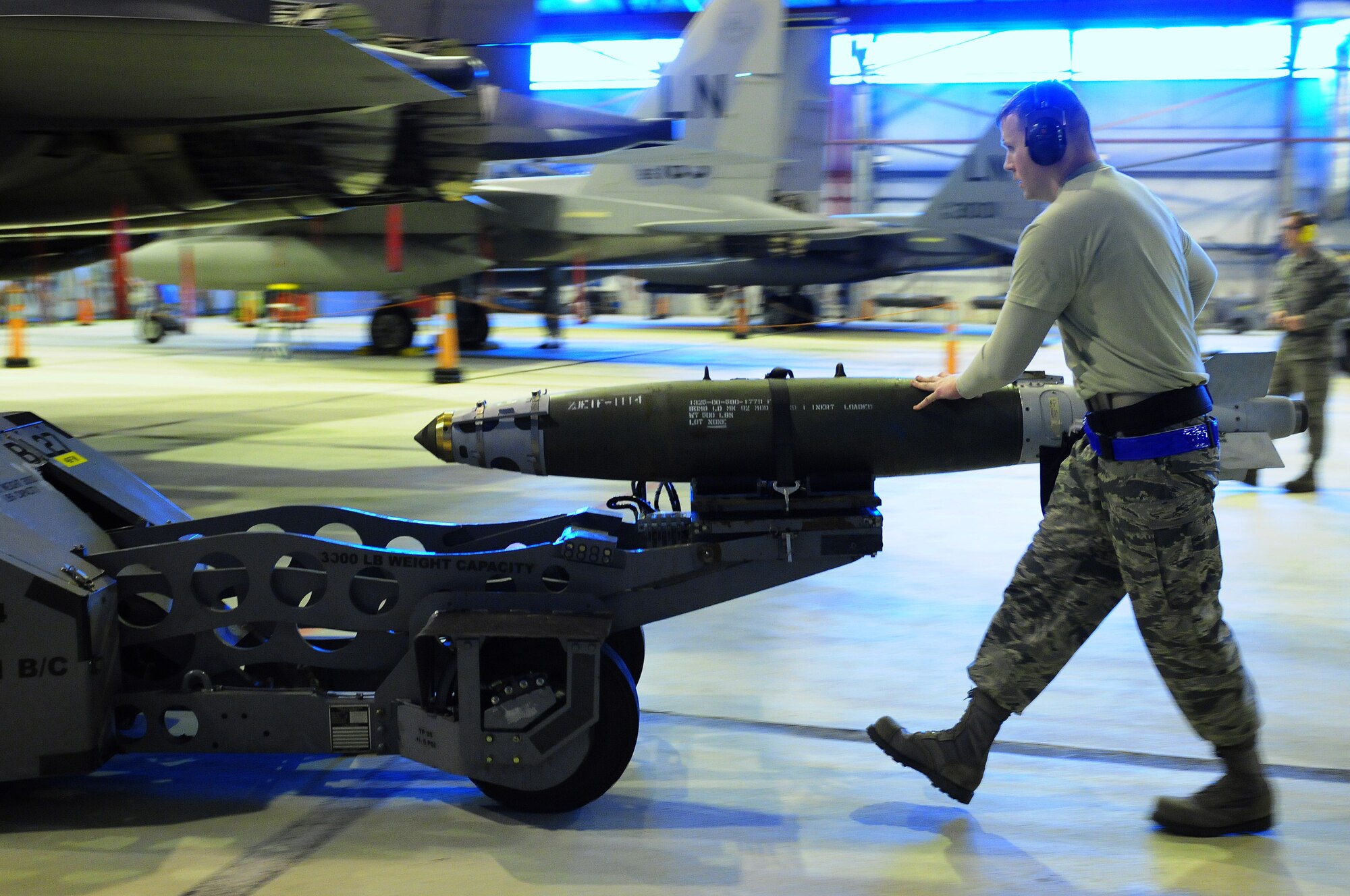 ROYAL AIR FORCE LAKENHEATH, England -- Staff Sgt. Stephen Hansen, 492nd Aircraft Maintenance Unit weapons load crew team chief, transports munitions to load on an F-15E Strike Eagle during the quarterly Load Crew Competition, Jan. 6, 2012. The quarterly competition features the best load crew teams from the 492nd, 493rd and 494th AMUs. The winner is determined by the fastest time loading munitions with the least amount of errors. (U.S. Air Force photo by Senior Airman Lausanne Morgan)