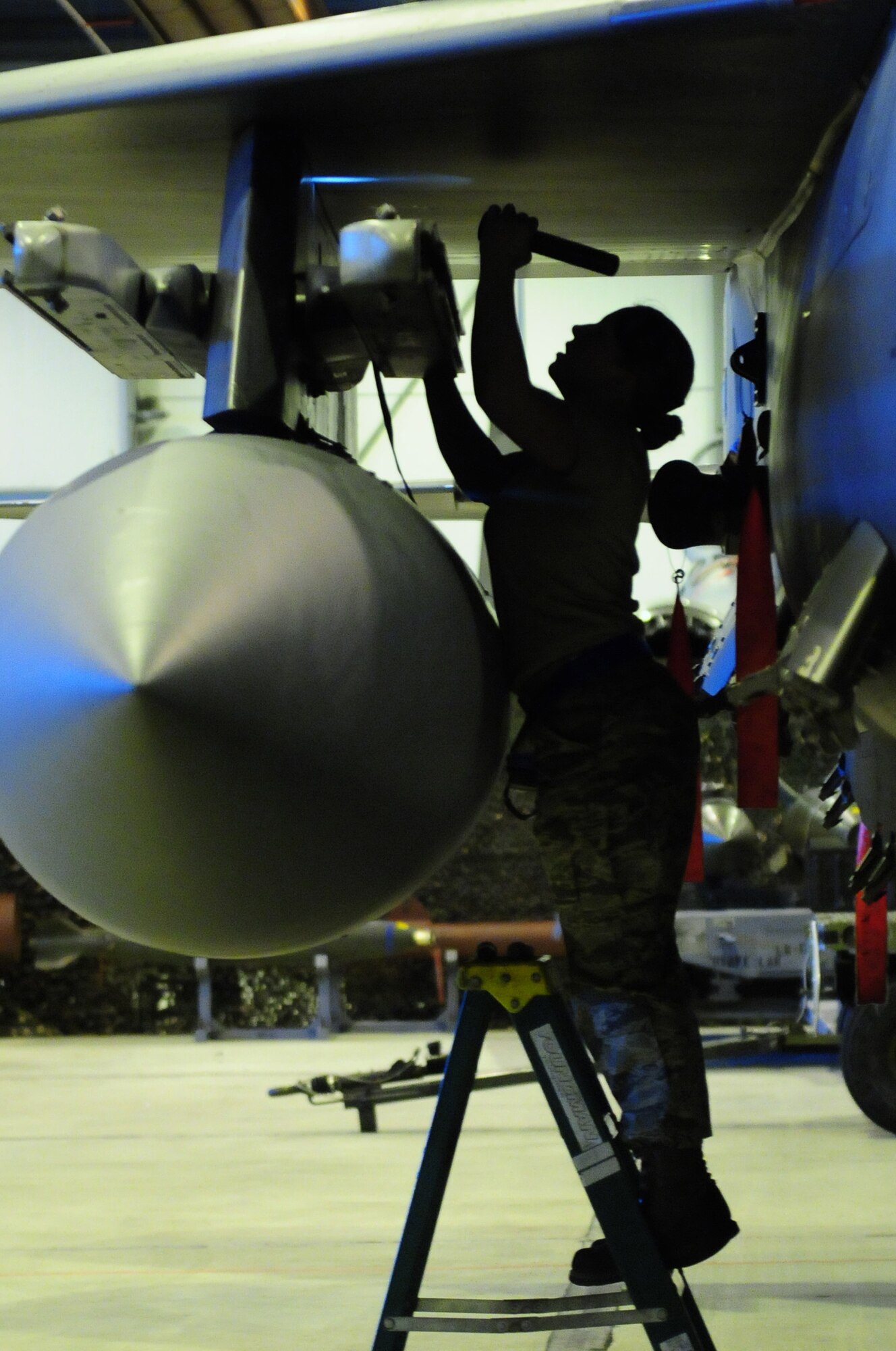ROYAL AIR FORCE LAKENHEATH, England -- Senior Airman Lori Morton, 492nd Aircraft Maintenance Unit weapons load crew team member, inspects an F-15E Strike Eagle model wing weapon pylon for safety and security prior to weapons loading during the quarterly Load Crew Competition, Jan. 6, 2012. The quarterly competition features the best load crew teams from the 492nd, 493rd and 494th AMUs. The winner is determined by the fastest time loading munitions with the least amount of errors. (U.S. Air Force photo by Senior Airman Lausanne Morgan)