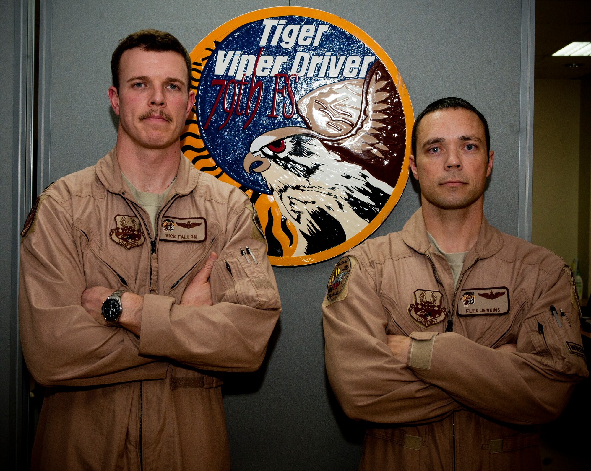 Capt. Charles Fallen and Maj. Greg Jenkins, 79th Expeditionary Fighter Squadron pilots, pose for a photo next to their squadron patch Jan. 10, 2012 at an undisclosed location in Southwest Asia. Fallen and Jenkins are both instructor pilots at Luke Air Force Base, Ariz. (photo by Staff Sgt. Joshua Garcia)