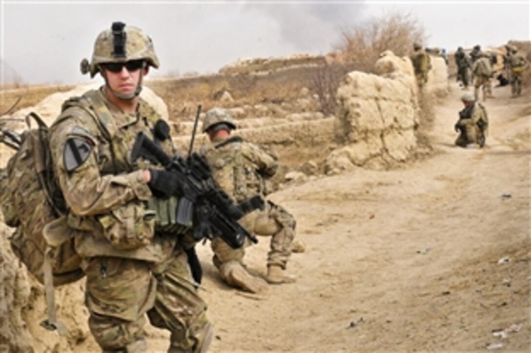 U.S. Army Sgt. Joshua Oakley, left, pulls rear security while on patrol in the village of Shengazi, Afghanistan, Jan. 3, 2012. Oakley is a team leader assigned to the 25th Infantry Division's Company B, 1st Battalion, 5th Infantry Regiment, 1st Stryker Brigade Combat Team.