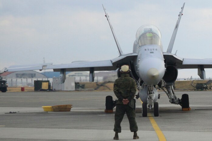 Marine All-Weather Fighter Attack Squadron 242 pilots wait to be cleared for take off during the surge day that took place at the air field here Jan. 12. A surge day is done to test a squadrons capabilities by rapidly  proucing sorties to ensure readiness and proficiency in combat scenarios.