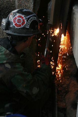 A technical rescue Marine with Chemical Biological Incident Response Force’s Technical Rescue Platoon attempts to cut through a steel plate in order to gain access to a tunnel where rescuers believe “victims” could be trapped during a simulated collapse during the joint 72-hour technical rescue training operation with the 911th U.S. Army Technical Rescue Engineer Company at the Downey Responder Training Facility. This technical rescue training operation at DRTF allowed the two units take the opportunity to train together to build a good working relationship and familiarity of each other’s capabilities and limitations, since they both cover the National Capitol Region they would work together if there were ever a disaster.
