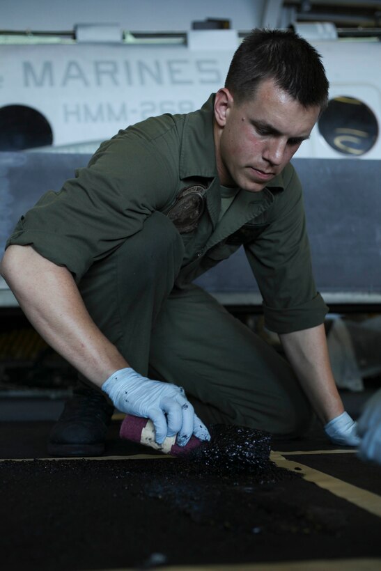 Indianapolis native Cpl. Karsten Foerster, 22, resurfaces a floor panel for a CH-46E Sea Knight aboard USS Makin Island (LHD 8) here Jan. 11. Foerster serves as an air-frame mechanic with Marine Medium Helicopter Squadron 268 (Reinforced), the aviation combat element for the 11th Marine Expeditionary Unit. The unit is currently deployed aboard the amphibious assault ship as part of the Makin Island Amphibious Ready Group (MKIARG), which is a U.S. Central Command theater reserve force. The group is also providing support for maritime security operations and theater security cooperation efforts in the U.S. 5th Fleet area of responsibility.