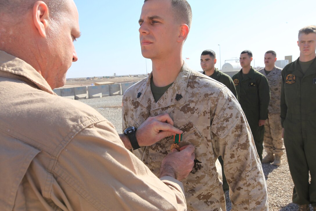 Lt. Col. Ian Clark, left, the commanding officer of Marine Light Attack Helicopter Squadron 369, pins the Navy and Marine Corps Achievement Medal on Sgt. Christopher Lemke during a ceremony at Camp Bastion, Afghanistan, Jan. 12. Lemke, a mechanic with the squadron, and a native of Macomb, Mich., discovered a previously unknown issue with the UH-1Y Huey helicopter that represented an extreme risk to the aircraft and aircrew.