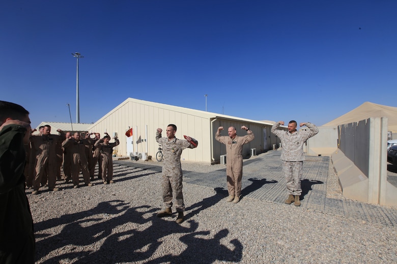 The Marines of Marine Light Attack Helicopter Squadron 369 render the “Gunfighter Salute” at a ceremony for Sgt. Christopher Lemke’s Navy and Marine Corps Achievement Medal at Camp Bastion, Afghanistan, Jan. 12. Lemke, a mechanic with the squadron, and a native of Macomb, Mich., discovered a previously unknown issue with the UH-1Y Huey helicopter that represented an extreme risk to the aircraft and aircrew.