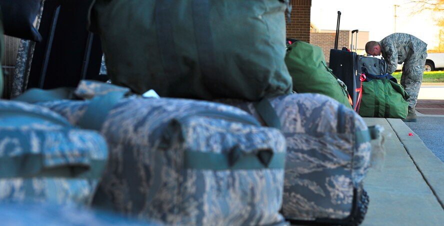 A Member of the 55th Expeditionary Fighter Squadron secures his gear before its loaded on a C-5 Galaxy, Jan. 6, 2012. Three C-5s and a C-17 landed at Shaw Air Force Base S.C., over a three-day period to pick up approximately 250 Airmen and supplies in support of a deployment tasking to Kunsan Air Base in Republic of Korea. (U.S. Air Force Photo by Senior Airman Neil D. Warner/Released) 