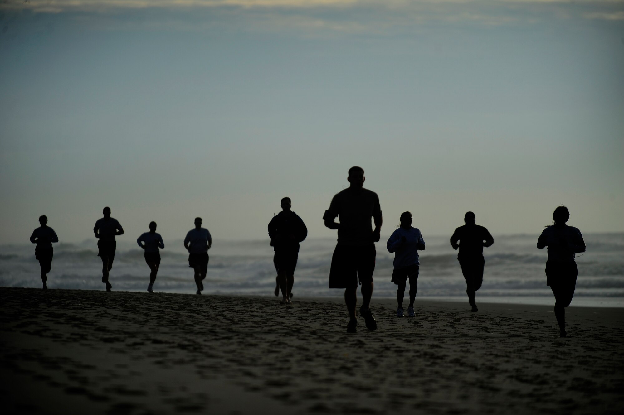 VANDENBERG AIR FORCE BASE, Calif. -- Team V members run on Wall Beach here during Col. Richard Boltz, 30th Space Wing commander's final run Wednesday, Jan. 11, 2012. More than 80 Vandenberg members ran three miles with the commander as a farewell gesture for him. (U.S. Air Force photo/Staff Sgt. Andrew Satran) 

 