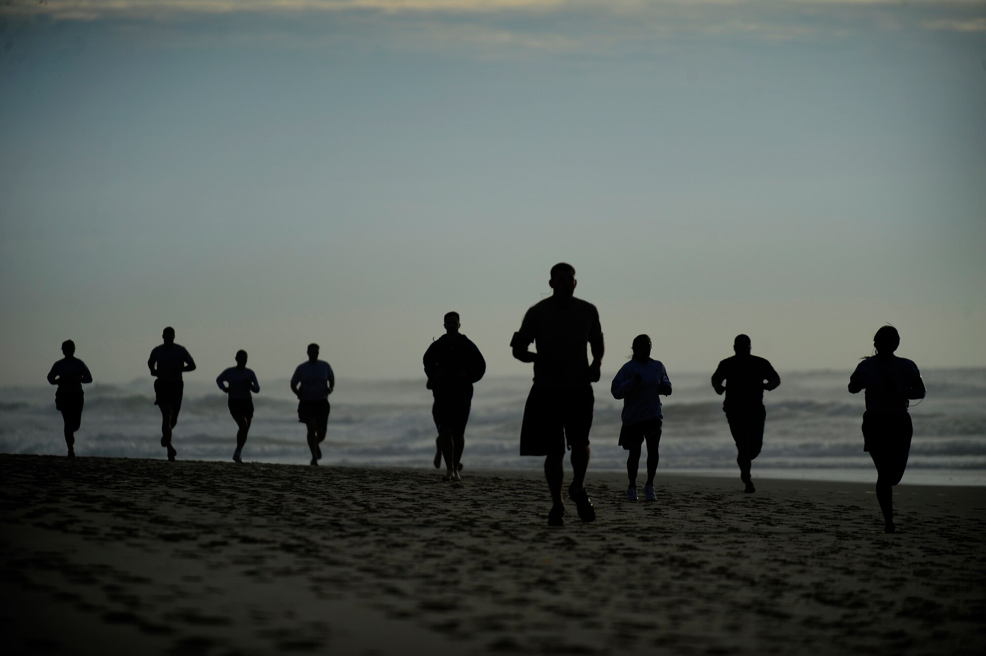 VANDENBERG AIR FORCE BASE, Calif. -- Team V members run on Wall Beach here during Col. Richard Boltz, 30th Space Wing commander's final run Wednesday, Jan. 11, 2012. More than 80 Vandenberg members ran three miles with the commander as a farewell gesture for him. (U.S. Air Force photo/Staff Sgt. Andrew Satran) 

 