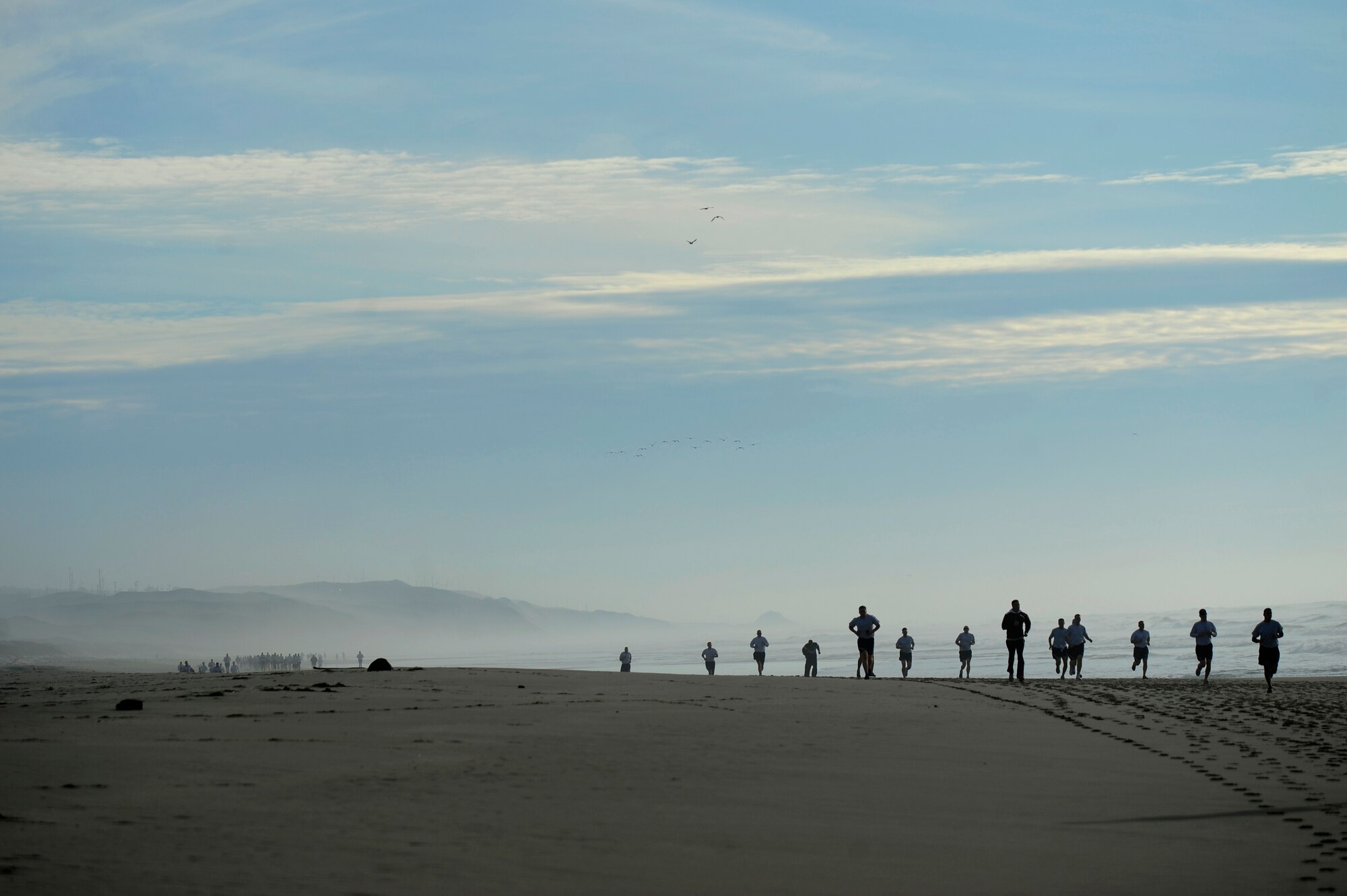 VANDENBERG AIR FORCE BASE, Calif. -- Team V members run on Wall Beach here during Col. Richard Boltz, 30th Space Wing commander's final run Wednesday, Jan. 11, 2012. More than 80 Vandenberg members ran three miles with the commander as a farewell gesture for him. (U.S. Air Force photo/Staff Sgt. Andrew Satran) 

 