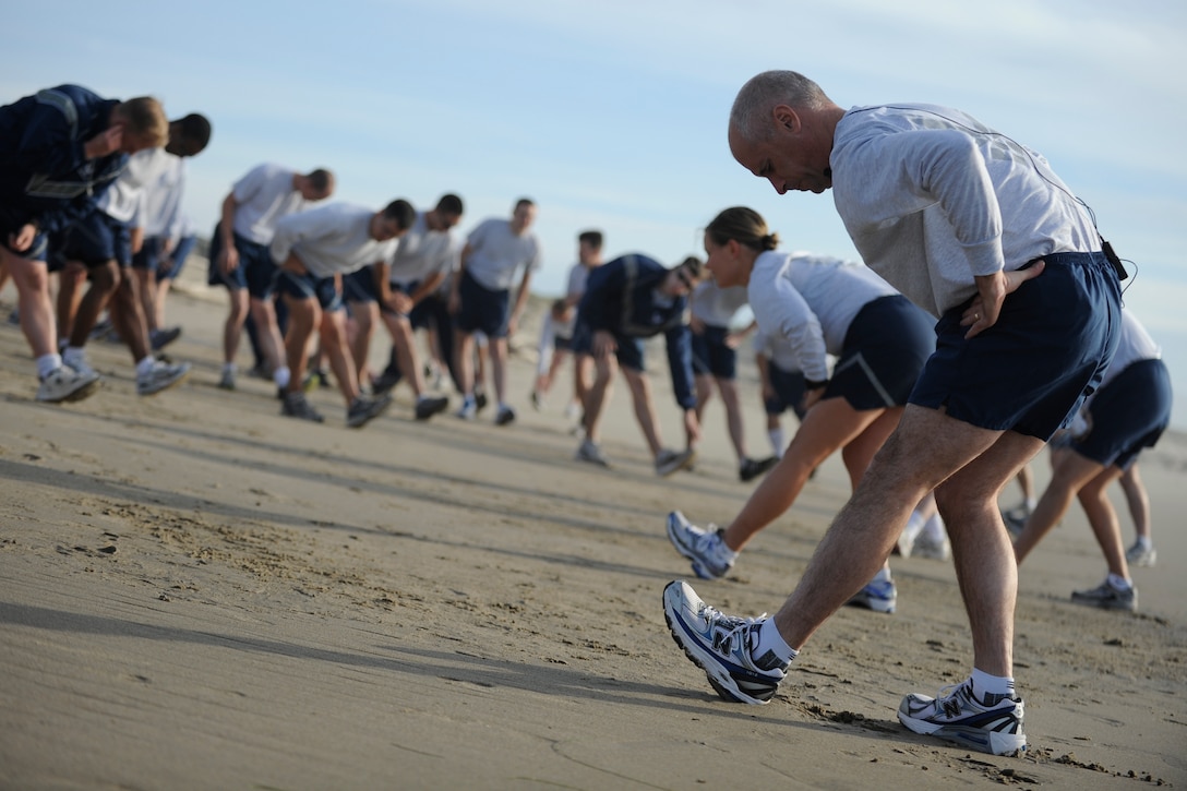 VANDENBERG AIR FORCE BASE, Calif. -- Col. Richard Boltz, 30th Space Wing commander, stretches with Vandenberg Airmen before his final run as commander at Wall Beach here Wednesday, Jan. 11, 2012. More than 80 Vandenberg members ran three miles with the commander as a farewell gesture for him. (U.S. Air Force/Staff Sgt. Levi Riendeau)
