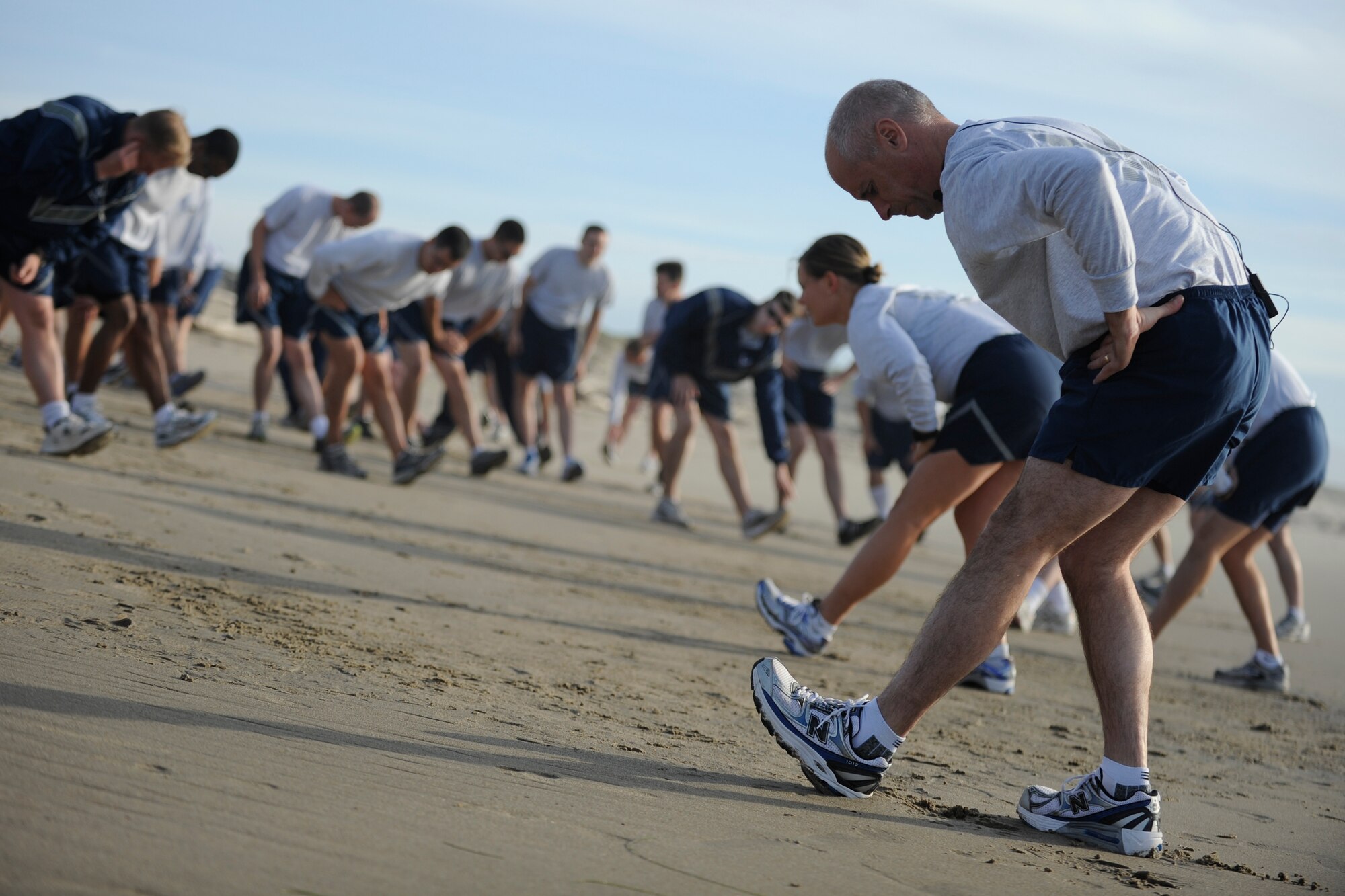 VANDENBERG AIR FORCE BASE, Calif. -- Col. Richard Boltz, 30th Space Wing commander, stretches with Vandenberg Airmen before his final run as commander at Wall Beach here Wednesday, Jan. 11, 2012. More than 80 Vandenberg members ran three miles with the commander as a farewell gesture for him. (U.S. Air Force/Staff Sgt. Levi Riendeau)
