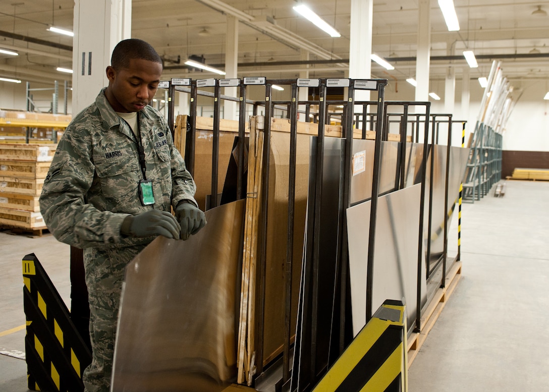 Airman 1st Class Terrell Harris, 28th Logistics Readiness Squadron supply technician, selects a piece of sheet metal to complete an order at the 28th LRS supply shop on Ellsworth Air Force Base, S.D., Jan. 11, 2012. The staff maintains more than 11,000 assets, to support requests from multiple sections around the base. (U.S. Air Force photo by Airman Alystria Maurer/Released)