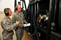 U.S. Air Force Staff Sgt. David Harris and Airman 1st Class Thomas Asbury, 20th Component Maintenance Squadron fuel technicians, work together on refueling procedures, Jan. 10, 2012. Three C-5s and a C-17 landed at Shaw Air Force Base S.C., over a three-day period to pick up Airmen and aerospace ground equipment in support of a deployment tasking. (U.S. Air Force Photo by Senior Airman Neil D. Warner/Released)