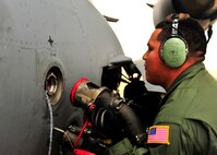 U.S. Air Force Staff Sgt. Jorge Vega, 437th Air Maintenance Unit flight crew chief, inserts a refueling hose into a C-17 Globemaster, Jan. 10, 2012. Three C-5s and a C-17 landed at Shaw Air Force Base S.C., over a three-day period to pick up Airmen and aerospace ground equipment in support of a deployment tasking. (U.S. Air Force Photo by Senior Airman Neil D. Warner/Released)