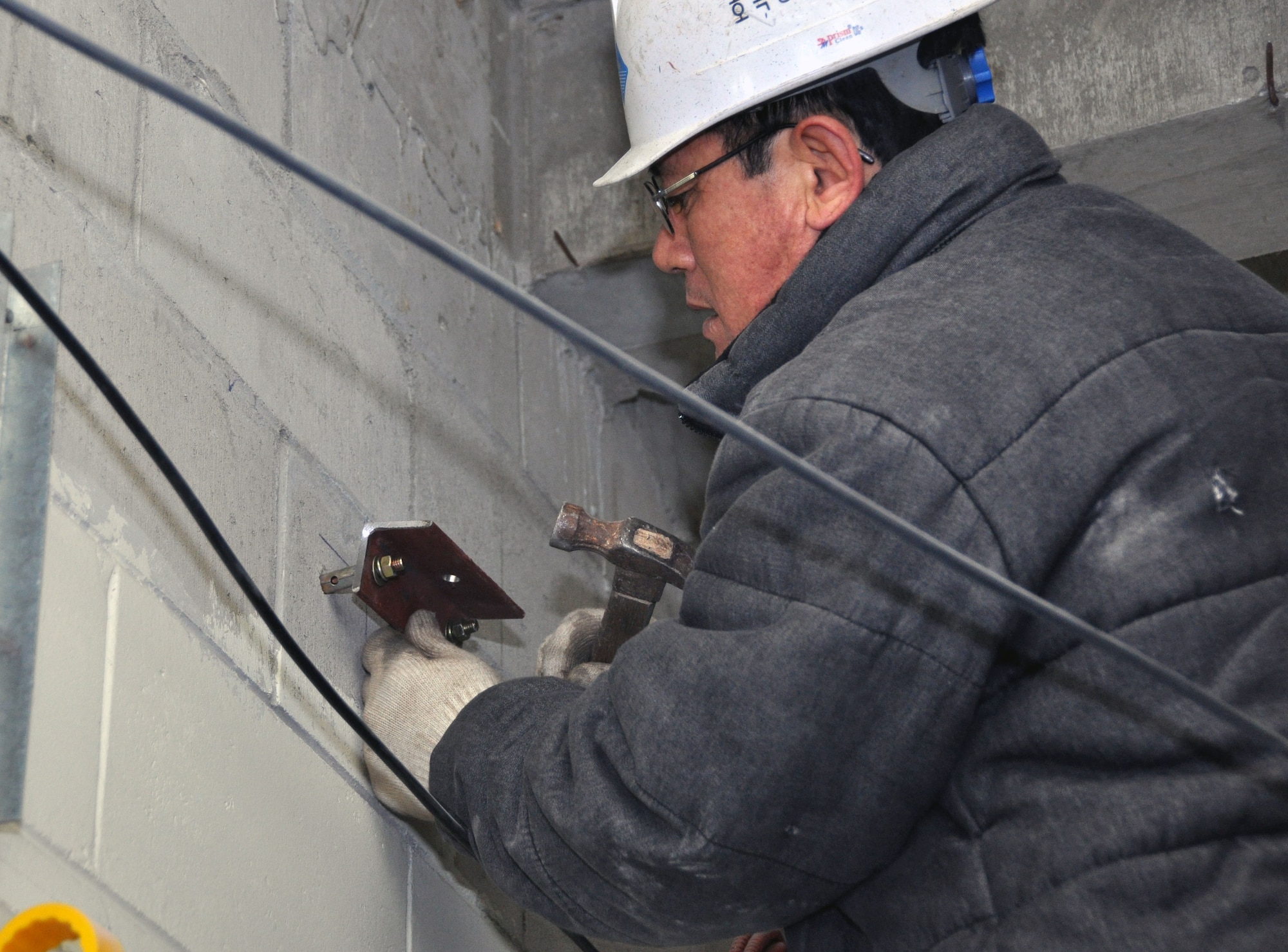 A contractor working with the 51st Civil Engineer Squadron renovates a hallway in Dorm 1365 on Jan. 11, 2012, at Osan Air Base, South Korea. (U.S. Air Force photo/ Airman 1st Class Michael Battles)