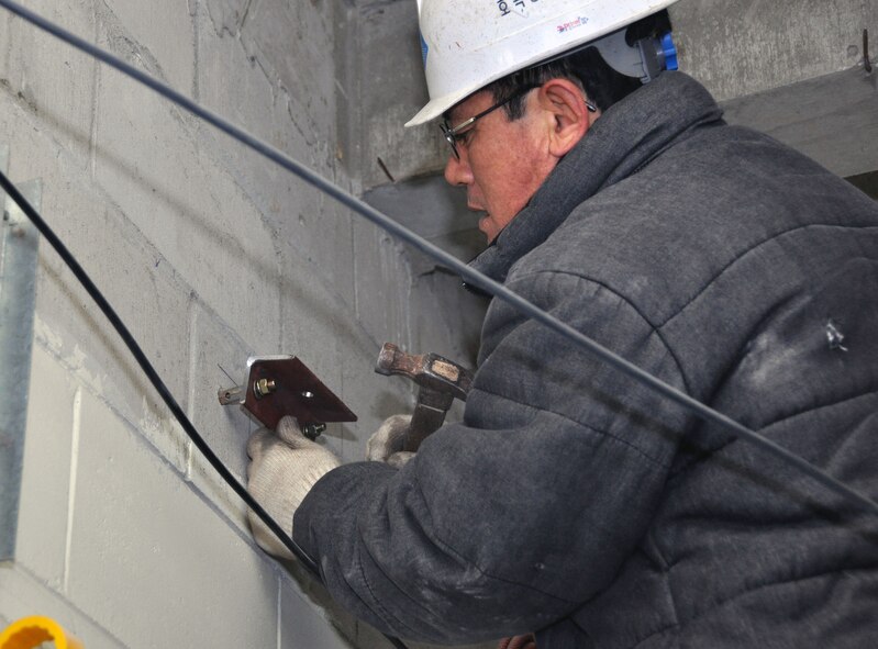 A contractor working with the 51st Civil Engineer Squadron renovates a hallway in Dorm 1365 on Jan. 11, 2012, at Osan Air Base, South Korea. (U.S. Air Force photo/Airman 1st Class Michael Battles) 

