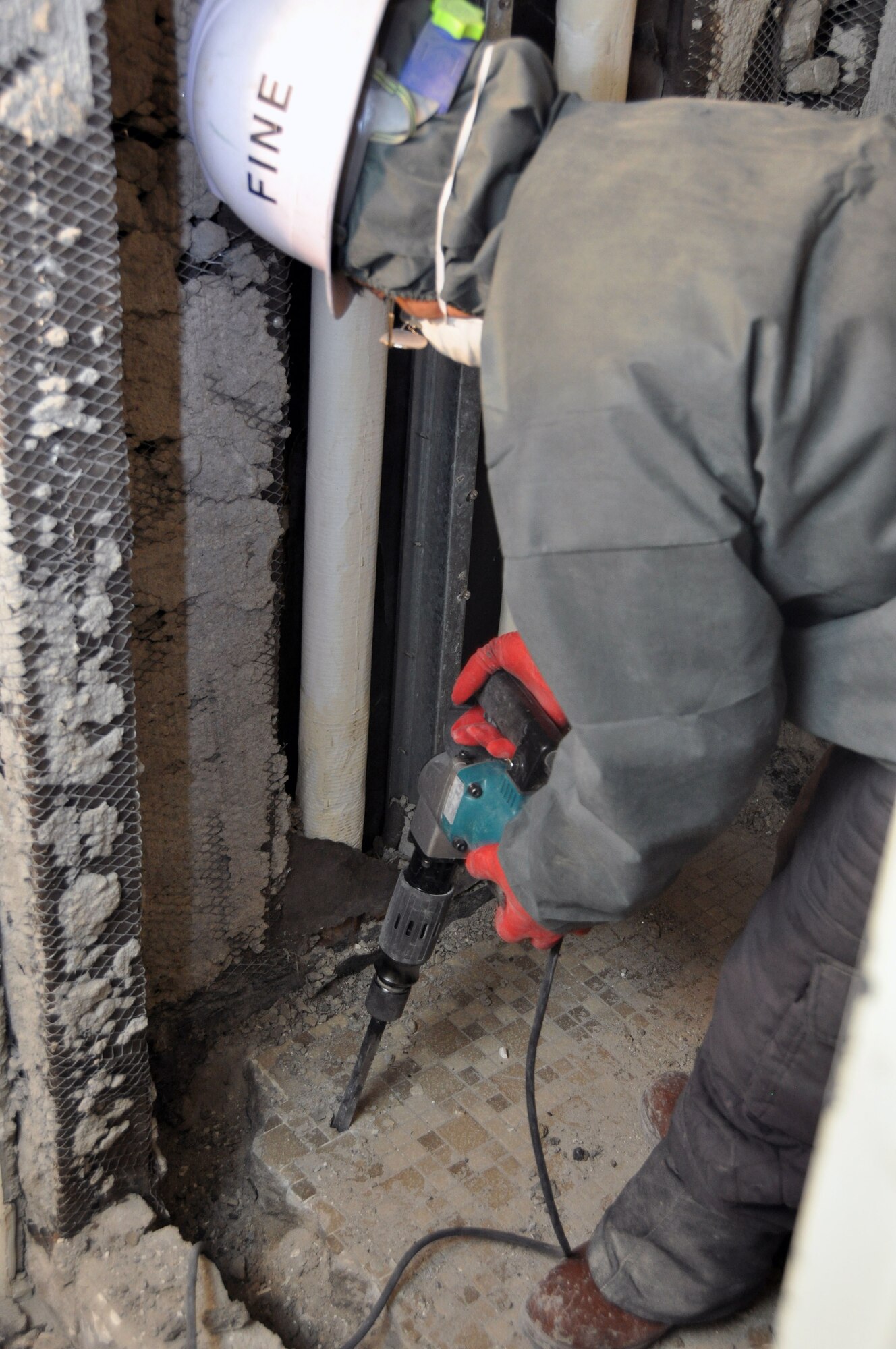 A contractor working with the 51st Civil Engineer Squadron renovates a bathroom in Dorm 1365, Jan. 11, 2012, at Osan Air Base, South Korea. (U.S. Air Force photo/ Airman 1st Class Michael Battles)