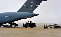 Members of the 20th Logistics Readiness Squadron load cargo onto a C-17 Globemaster, Jan. 10, 2012. Three C-5s and a C-17 landed at Shaw Air Force Base S.C., over a three-day period to pick up Airmen and supplies in support of a deployment tasking. (U.S. Air Force Photo by Senior Airman Neil D. Warner/Released)