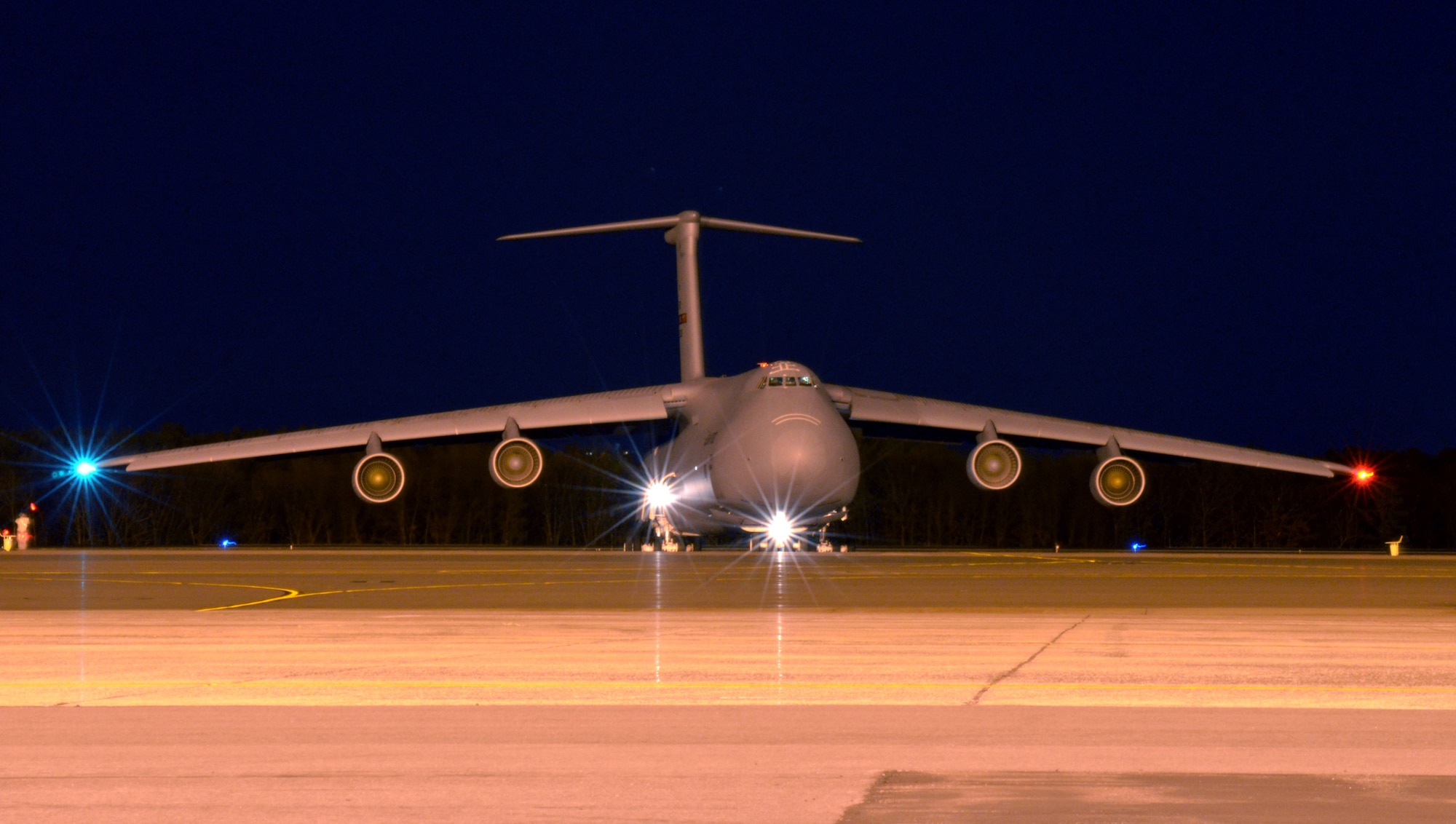 A C-5 Galaxy gives a "light show" just before taxiing out for an evening flight. (U.S. Air Force photo/SrA. Kelly Galloway)