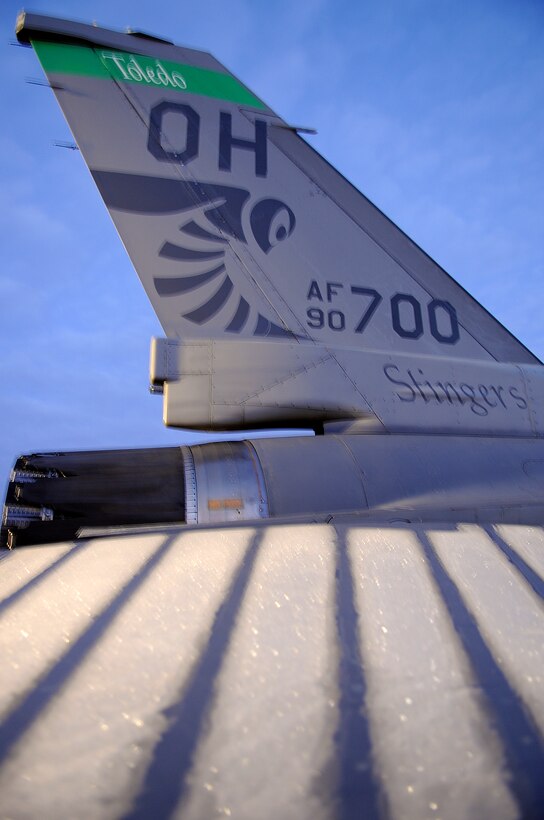 An F-16CG aircraft defrosts on the flightline in the early morning hours at the 180th Fighter Wing, Ohio Air National Guard, Swanton, Ohio. The 180th Fighter Wing performed a unit training assembly Jan. 7 and 8, 2012 where traditional status guardsmen participate in once monthly training activities such as flying and maintaining these aircraft.(U.S. Air Force photo by Master Sgt. Beth Holliker/Released)