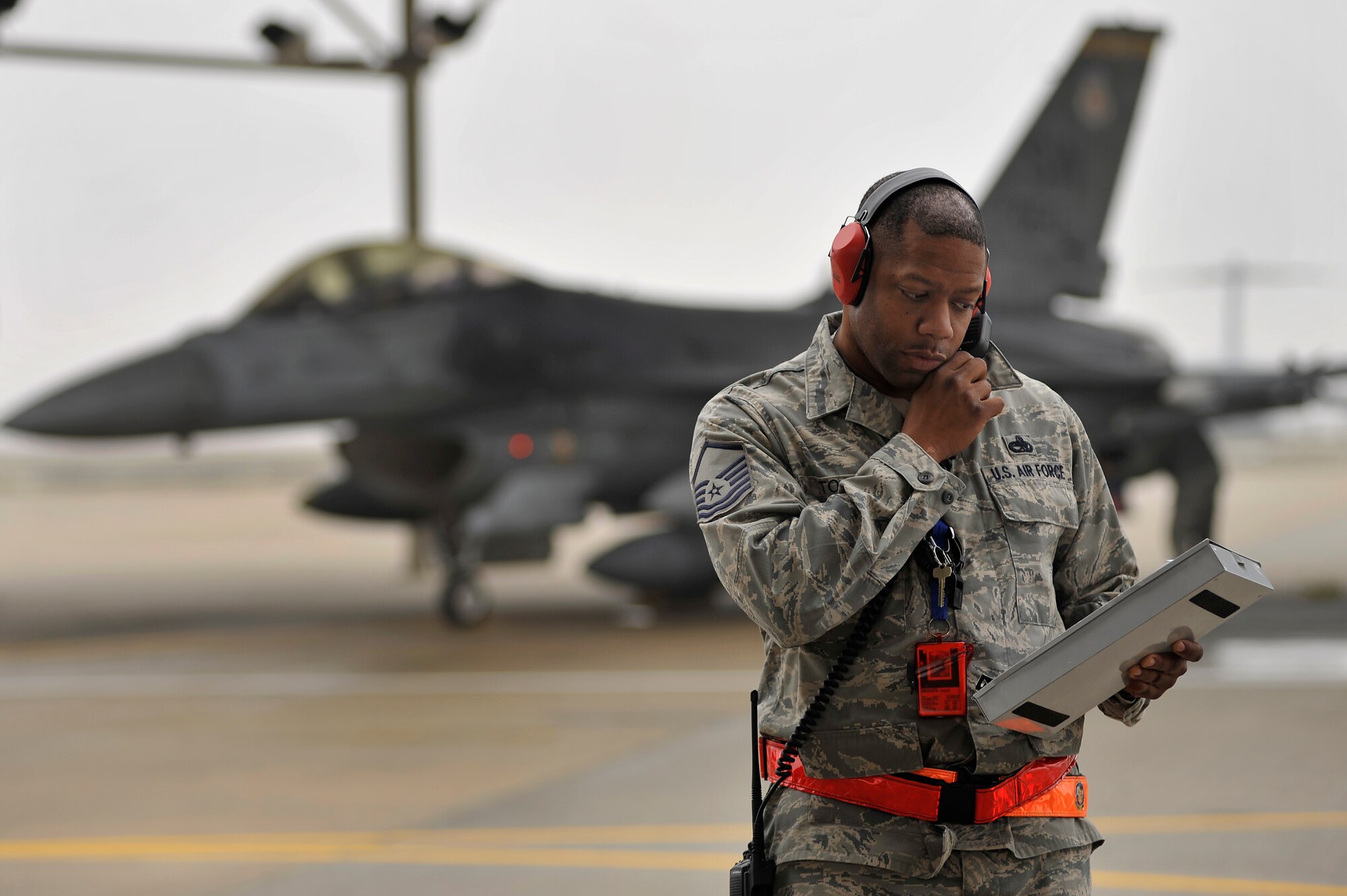 U.S. Air Force Master Sgt. Maurice Toole, 20th Aircraft Maintenance Squadron, communicates with aircraft maintainers as he completes his preflight checklist before launching F-16 Fighting Falcon aircraft, Jan. 10, 2012, Shaw Air Force Base, S.C. Twelve F-16 aircraft and approximately 250 Airmen deployed to Kunsan Air Base, South Korea for a three-month deployment. The Airmen were activated as the 55th Expeditionary Fighter Squadron. (U.S. Air Force photo by Senior Airman Kenny Holston/Released)


