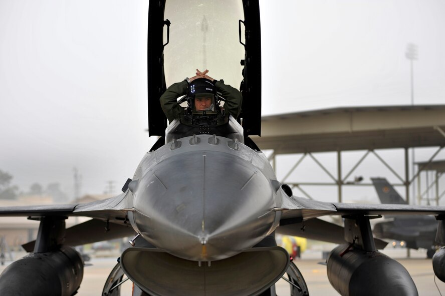 U.S. Air Force Capt. David Auston, 55th Fighter Squadron F-16 Fighting Falcon pilot, gets adjusted in the cockpit of his F-16 before launching, Jan. 10, 2012, Shaw Air Force Base, S.C. Twelve F-16 aircraft and approximately 250 Airmen deployed to Kunsan Air Base, South Korea for a three-month deployment. The Airmen were activated as the 55th Expeditionary Fighter Squadron. (U.S. Air Force photo by Senior Airman Kenny Holston/Released)