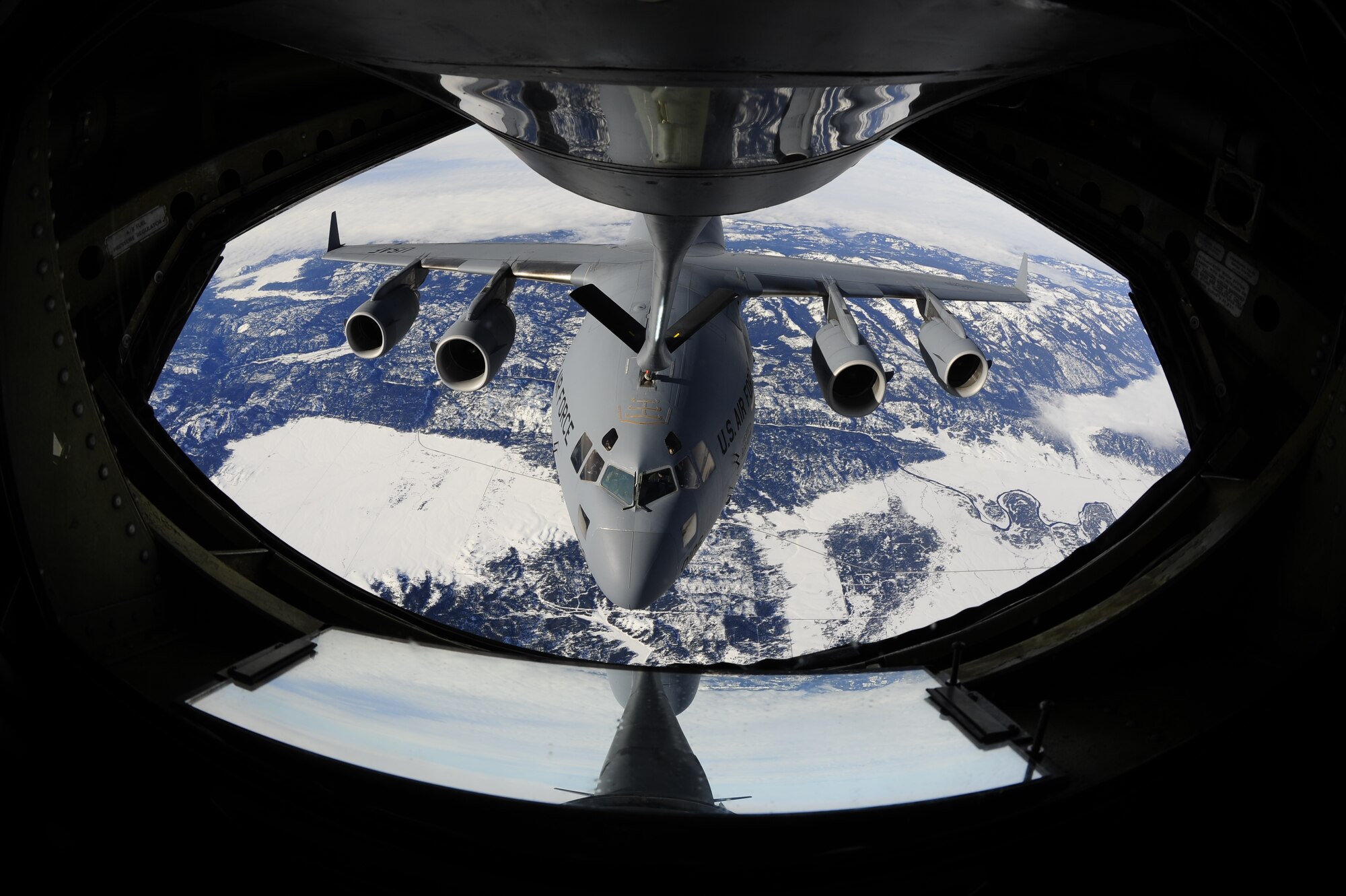 A C-17 Globemaster, from Joint Base Lewis-McChord, Wash. is refueled by a KC-135 Stratotanker, flown and operated by Fairchild Air Force Base pilots and crew over Montana, Jan. 28. (U.S. Air Force Photo/ Airman 1st Class Taylor Curry)