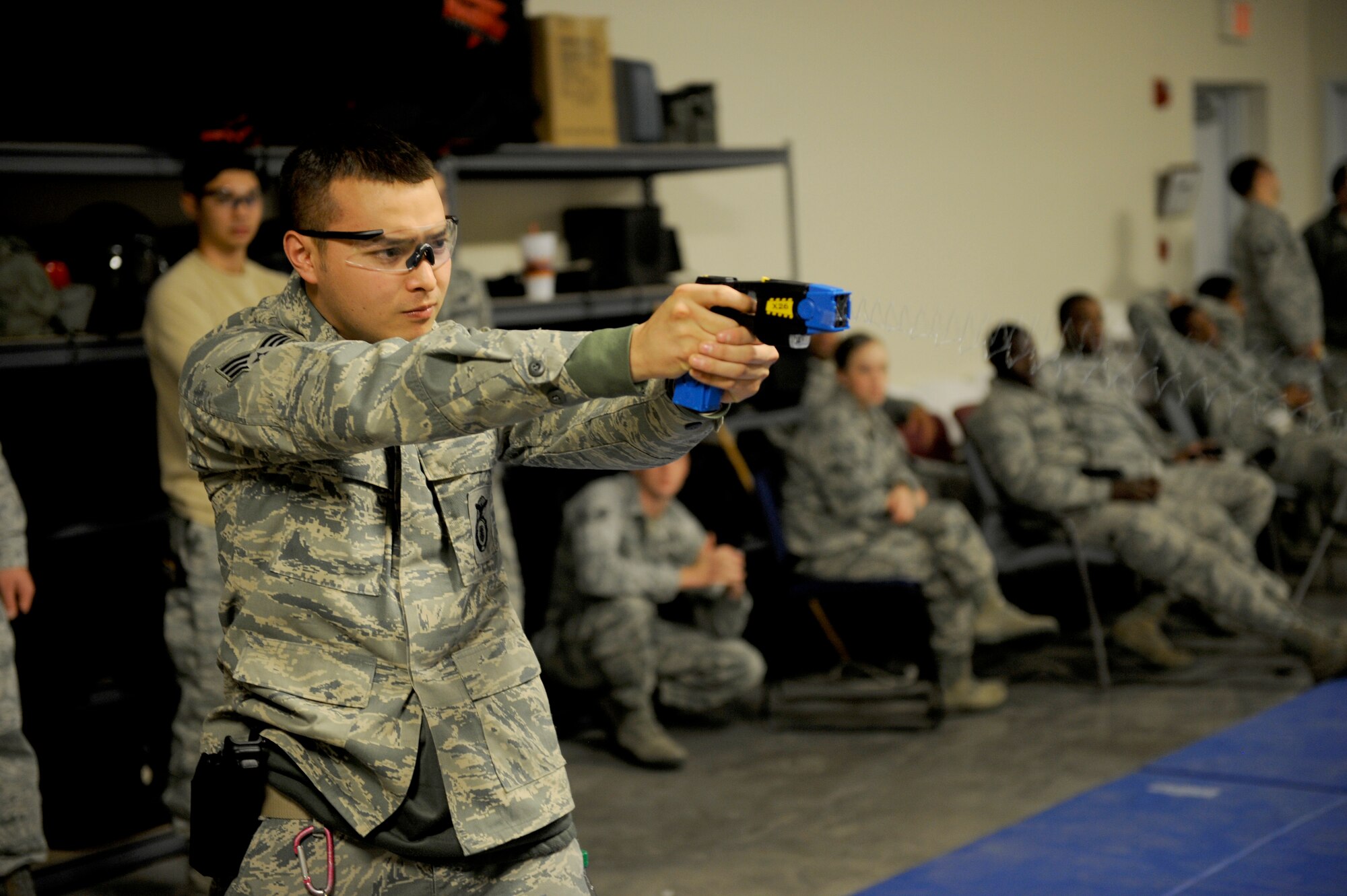 Senior Airman Matthew Shirota, 92nd Security Forces Squadron, receives training on the Tazer Dec. 14. Security Forces will be carrying Tasers soon. (U.S. Air Force photos/Airman 1st Class Earlandez Young) 