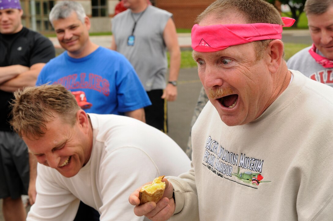 Senior Master Sgt. Kevin Ahearn, of Team Hot Pink, is cheered on by his teammates during the pie eating contest as part of Sports Day 2011.  Sports Day is an event where wing members compete in a variety of indoor and outdoor activities which test their cognitive skills and showcase their athletic abilities.  The morning began with members being divided up into 25 teams, but by sunset only one team remained. Team Black defeated a valiant Team Yellow Jun. 5, 2011 to win the championship.

Established in October of 2007, Sports Day was created to bring the unit together after several deployments and the hot summer which took place that year. The goal is to foster camaraderie, have fun, and work together as a team.