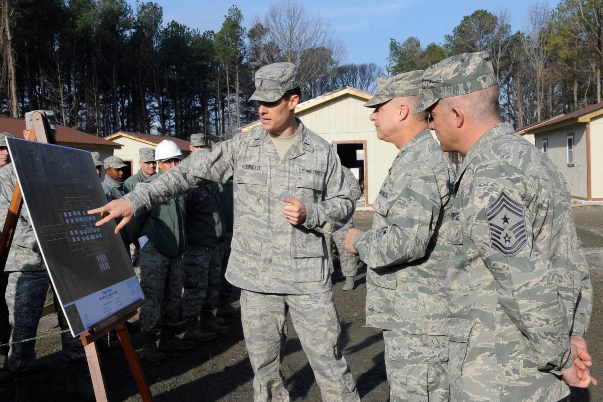 U.S. Air Force 1st Lt. Eric Robinette, 633rd Civil Engineer Squadron programs flight officer in charge, gives a mission briefing to Maj. Gen. Lawrence Wells, 9th Air Force commander, and Chief Master Sgt. Robert Brooks, 9th AF command chief, during a visit to Langley Air Force Base, Va., Jan. 10, 2012. Wells and Brooks visited both Langley AFB and Fort Eustis, getting a first-hand look at the diverse mission sets and operational capacities of each installation. (U.S. Air Force photo by Staff Sgt. Dana Hill/Released)