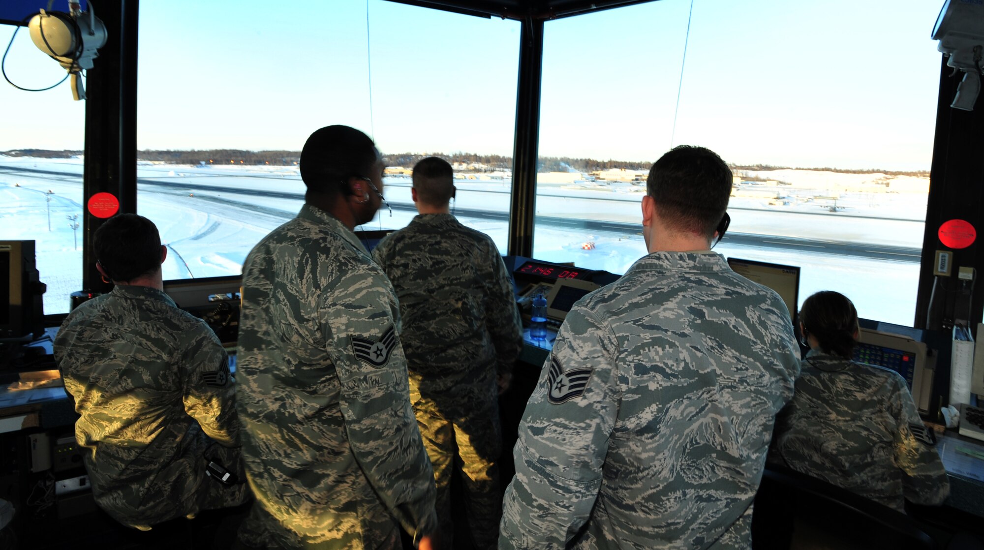 Airmen from the 3rd Operations Support Squadron air traffic control tower monitor the air space around Joint Base Elmendorf-Richardson, Alaska., Dec. 12, 2011. JBER's air traffic controllers handle an average of 150 flights daily to include directing the movement of aircraft into and out of the military airfields, relay flights and landing instructions, weather reports and safety informations to pilots. (U.S. Air Force photo/Staff Sgt. Sheila deVera)

 