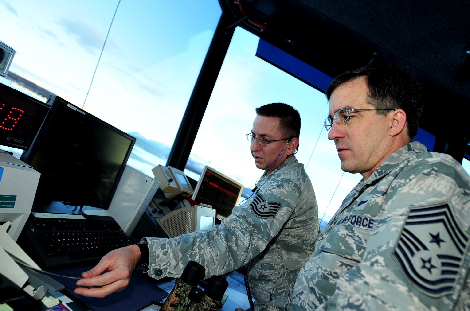 Tech. Sgt. Joseph Sollers shows Chief Master Sgt. Steven Bohannon, 3rd Wing command chief, a flight plan of multiple aircraft on Dec. 12, 2011 at Joint Base Elmendorf-Richardson, Alaska. JBER's air traffic controllers handle an average of 150 flights daily to include directing the movement of aircraft into and out of the military airfields, relay flights and landing instructions, weather reports and safety informations to pilots. Sollers is assigned to the 3rd Operations Support Squadron. (U.S. Air Force photo/Staff Sgt. Sheila deVera)

 